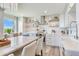 Gourmet kitchen showcasing floating shelves, stone countertops, stainless steel appliances, and a stylish tile backsplash at 100 Oakmont Ln # 310, Belleair, FL 33756