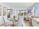 An open living room area featuring a decorative table and balcony access at 100 Oakmont Ln # 310, Belleair, FL 33756