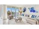 Bright living room featuring water view, modern decor, and lots of natural light at 100 Oakmont Ln # 310, Belleair, FL 33756