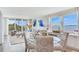 An open living room area with floor to ceiling windows and sliding glass doors to the balcony at 100 Oakmont Ln # 310, Belleair, FL 33756