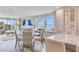An open living room and kitchen area with floor to ceiling windows and water views at 100 Oakmont Ln # 310, Belleair, FL 33756