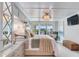 Bright main bedroom featuring a chandelier, balcony access, and a seating area at 100 Oakmont Ln # 310, Belleair, FL 33756