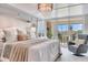 Bright main bedroom featuring a chandelier, balcony access, and a seating area at 100 Oakmont Ln # 310, Belleair, FL 33756