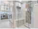 Bathroom walk-in shower featuring a built-in bench and mosaic tile wall at 100 Oakmont Ln # 310, Belleair, FL 33756