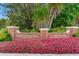 Entrance to Belleair Country Club and Belleview Inn, framed by lush landscaping and colorful flowers at 100 Oakmont Ln # 310, Belleair, FL 33756