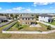 Aerial view of the home's backyard with a well-manicured lawn at 10106 Count Fleet Dr, Ruskin, FL 33575