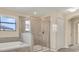 Bathroom featuring tiled shower, soaking tub, and bright window at 10106 Count Fleet Dr, Ruskin, FL 33575