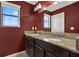 Bathroom with double sinks, granite countertop, vanity and a large framed mirror at 10106 Count Fleet Dr, Ruskin, FL 33575