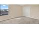 Bright and spacious bedroom with neutral carpeting and a large window with natural light at 10106 Count Fleet Dr, Ruskin, FL 33575