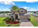 Beautiful exterior view of the home with lush landscaping and lake view at 10106 Count Fleet Dr, Ruskin, FL 33575