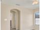 Hallway with neutral walls, arched doorways and natural light at 10106 Count Fleet Dr, Ruskin, FL 33575