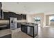 Modern kitchen featuring stainless steel appliances, granite countertops, and dark cabinetry at 10106 Count Fleet Dr, Ruskin, FL 33575