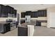 Modern kitchen featuring stainless steel appliances, granite countertops, and dark cabinetry at 10106 Count Fleet Dr, Ruskin, FL 33575