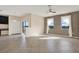 Open-concept living space featuring tile flooring, a ceiling fan, and access to the patio at 10106 Count Fleet Dr, Ruskin, FL 33575