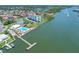 Stunning aerial view of waterfront condo community with pool, tennis courts, and dock access on a sunny day at 10216 Regal Dr # 208, Largo, FL 33774