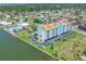 Aerial view of the condo, with views of community pool, tennis courts, and waterfront at 10216 Regal Dr # 208, Largo, FL 33774