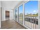 Bright sunroom with a view of the parking lot and palm trees, accessed through sliding glass doors at 10216 Regal Dr # 208, Largo, FL 33774