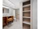 Stylish bathroom featuring a vanity with unique storage drawers, a standing shower, and built in shelves at 10216 Regal Dr # 208, Largo, FL 33774