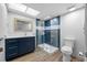Stylish bathroom featuring a glass-enclosed shower and navy vanity at 10216 Regal Dr # 208, Largo, FL 33774