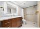 Modern bathroom showcasing an illuminated mirror, marble countertop, and a frameless glass shower at 10216 Regal Dr # 208, Largo, FL 33774