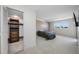 Bedroom with a light wood accent wall, plush carpet, a TV, and a closet for ample storage and entertainment at 10216 Regal Dr # 208, Largo, FL 33774