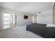Bright bedroom showcasing an open floor plan, light carpet, and sliding doors at 10216 Regal Dr # 208, Largo, FL 33774