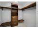 Walk-in closet with custom wood shelving and drawers for optimized storage and organization at 10216 Regal Dr # 208, Largo, FL 33774