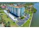 Beautiful condominium building with lush landscaping, covered parking, and a well-maintained exterior near the water at 10216 Regal Dr # 208, Largo, FL 33774