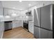 Sleek kitchen featuring stainless steel appliances, white cabinetry, and modern countertops at 10216 Regal Dr # 208, Largo, FL 33774