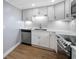 Well-lit kitchen featuring stainless appliances, white cabinetry, and sleek countertops for cooking at 10216 Regal Dr # 208, Largo, FL 33774