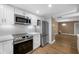 Updated kitchen showcases stainless appliances, white cabinets and opens to the living area at 10216 Regal Dr # 208, Largo, FL 33774