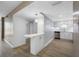 Modern kitchen with white cabinets, stainless steel appliances, and hardwood floors at 10216 Regal Dr # 208, Largo, FL 33774