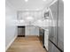 Modern kitchen features white cabinets, stainless steel appliances, and beautiful backsplash at 10216 Regal Dr # 208, Largo, FL 33774