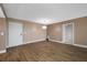 Spacious living room with neutral tones and wood-look floors offers versatility at 10216 Regal Dr # 208, Largo, FL 33774