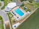 Aerial view of outdoor swimming pool with lounge chairs and umbrellas overlooking the water at 10216 Regal Dr # 208, Largo, FL 33774
