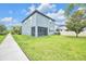 This backyard includes a screened-in patio and lush green grass at 1028 Oliveto Verdi Ct, Brandon, FL 33511