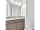 Bathroom featuring dark wood vanity and granite counters, with a large mirror at 1028 Oliveto Verdi Ct, Brandon, FL 33511