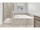 Bathroom features walk-in shower, tub with tile surround, and tile flooring at 1028 Oliveto Verdi Ct, Brandon, FL 33511