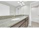 Bathroom featuring a double sink vanity with a granite countertop and undermount sinks at 1028 Oliveto Verdi Ct, Brandon, FL 33511