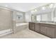 Bathroom features a walk-in shower, soaking tub, and double vanity with granite countertops at 1028 Oliveto Verdi Ct, Brandon, FL 33511