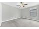 Bedroom featuring gray walls, carpet flooring, and a window at 1028 Oliveto Verdi Ct, Brandon, FL 33511