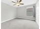 Bedroom with gray carpet, gray walls, ceiling fan, and window at 1028 Oliveto Verdi Ct, Brandon, FL 33511