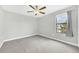Bedroom with carpet flooring, gray walls, and a window with curtains at 1028 Oliveto Verdi Ct, Brandon, FL 33511