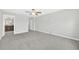 Bedroom with gray carpet, ceiling fan and neutral paint, and bathroom access at 1028 Oliveto Verdi Ct, Brandon, FL 33511