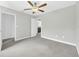 Bedroom featuring neutral walls, carpet flooring, ceiling fan, and attached bathroom at 1028 Oliveto Verdi Ct, Brandon, FL 33511