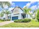 Two-story home featuring an attached two-car garage, with palm trees and manicured landscaping at 1028 Oliveto Verdi Ct, Brandon, FL 33511