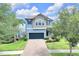 Charming two-story home featuring a paved driveway, lush landscaping, and beautiful curb appeal at 1028 Oliveto Verdi Ct, Brandon, FL 33511