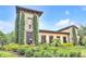 A charming clubhouse featuring stone accents and manicured landscaping at 1028 Oliveto Verdi Ct, Brandon, FL 33511