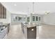A spacious kitchen with an island, granite countertops, stainless steel appliances, and an open-concept living space at 1028 Oliveto Verdi Ct, Brandon, FL 33511