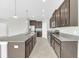 Well-appointed kitchen with granite countertops, stainless steel appliances, and a center island with a sink at 1028 Oliveto Verdi Ct, Brandon, FL 33511